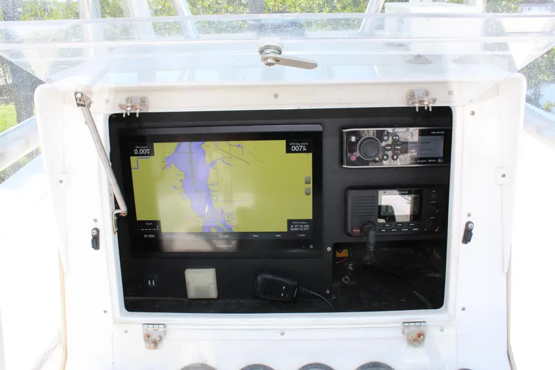 Slide: The Image of Dashboard of a 2002 Contender 31 CC boat with navigation and communication equipment. - 46