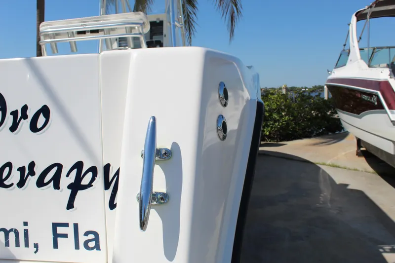 Slide: The Image of 2002 Contender 31 CC boat stern with cleat, docked under clear blue sky. - 8