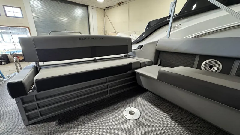 Slide: The Image of 2023 Bennington 25 LSB boat interior with gray seating and modern design. - 11