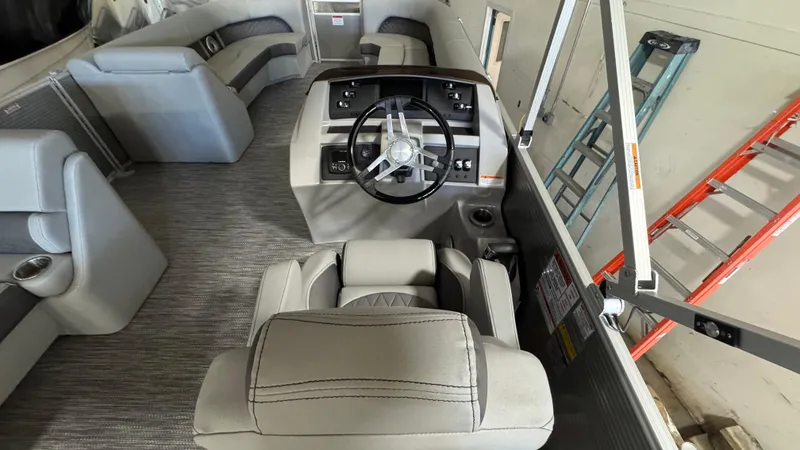 Slide: The Image of 2023 Bennington 25 LSB boat interior with steering wheel and seating. - 13