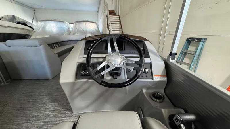 Slide: The Image of 2023 Bennington 25 LSB boat interior with steering wheel and control panel. - 14