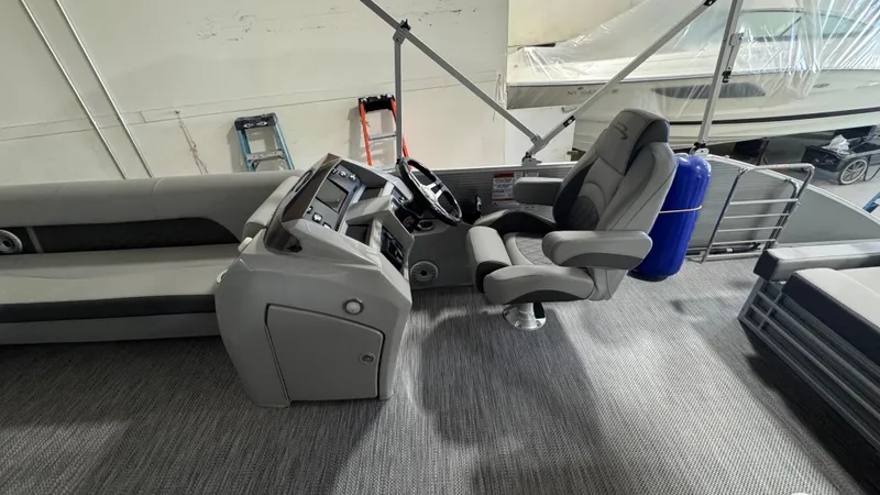 Slide: The Image of 2023 Bennington 25 LSB boat interior with captain's chair and control panel. - 15