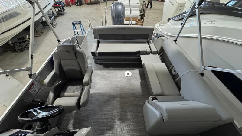 Slide: The Image of 2023 Bennington 25 LSB boat interior with gray seating and modern design. - 16