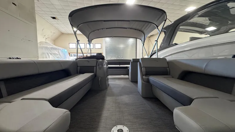 Slide: The Image of 2023 Bennington 25 LSB pontoon boat interior with spacious seating and canopy. - 22