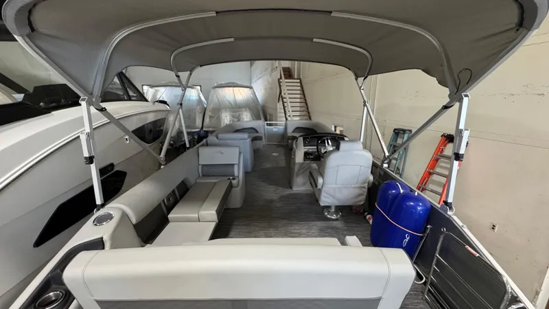 Slide: The Image of 2023 Bennington 25 LSB pontoon boat interior with gray seating and canopy. - 9