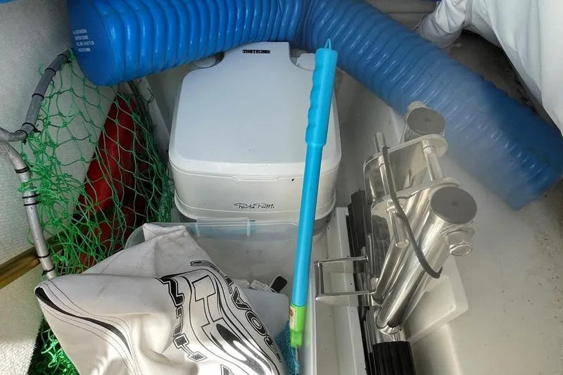 Slide: The Image of Storage compartment of 2021 Sea Hunt 239 Ultra SE with equipment and supplies. - 17