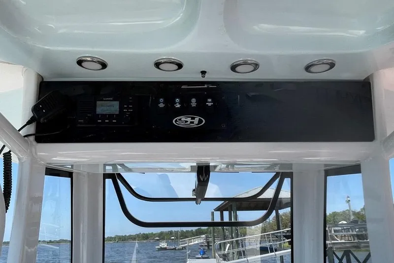 Slide: The Image of 2021 Sea Hunt 239 Ultra SE boat console with controls and view of water. - 20
