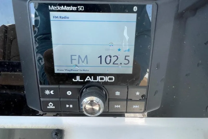 Slide: The Image of JL Audio MediaMaster 50 displaying FM 102.5 on Sea Hunt 239 Ultra SE, 2021 model. - 25