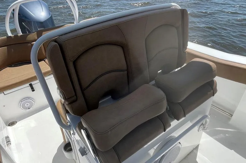 Slide: The Image of 2021 Sea Hunt 239 Ultra SE boat seats with brown cushions on a sunny day. - 27