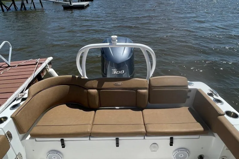 Slide: The Image of 2021 Sea Hunt 239 Ultra SE boat with tan seating and Yamaha 300 engine on water. - 29