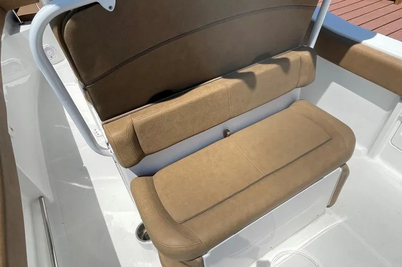 Slide: The Image of 2021 Sea Hunt 239 Ultra SE boat seat with brown upholstery and white frame. - 30