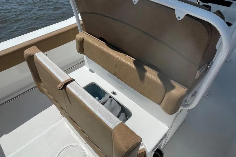 Slide: The Image of 2021 Sea Hunt 239 Ultra SE boat with tan seating and storage compartment. - 31