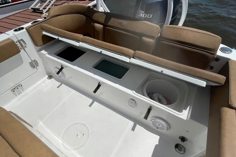 Slide: The Image of 2021 Sea Hunt 239 Ultra SE boat interior with storage compartments and seating. - 32