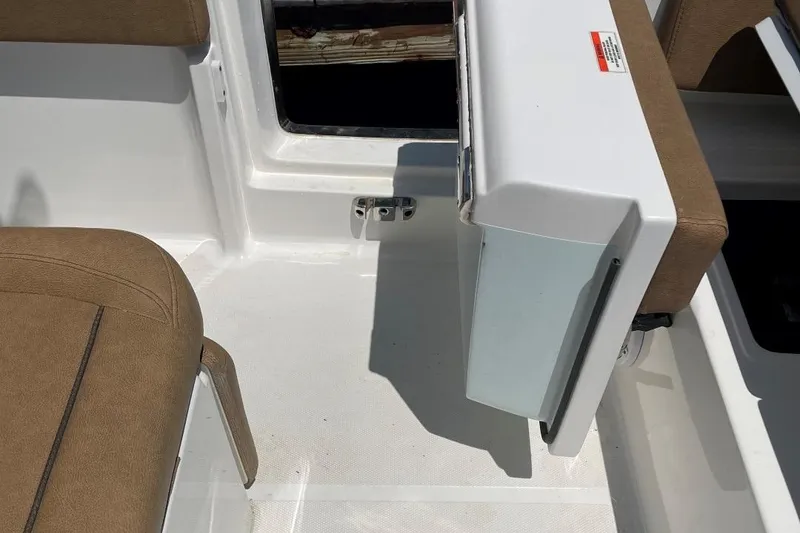 Slide: The Image of 2021 Sea Hunt 239 Ultra SE boat interior with tan seating and white flooring. - 33