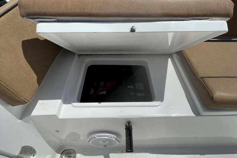 Slide: The Image of Open storage compartment on 2021 Sea Hunt 239 Ultra SE boat with cushioned seating. - 36