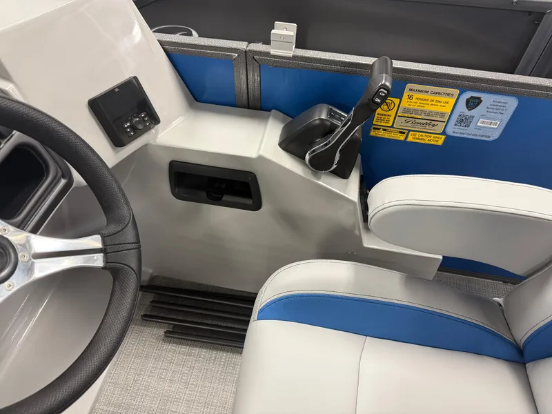 Slide: The Image of 2025 Bentley Pontoons Legacy 240 Cruise interior with steering wheel and control panel. - 13