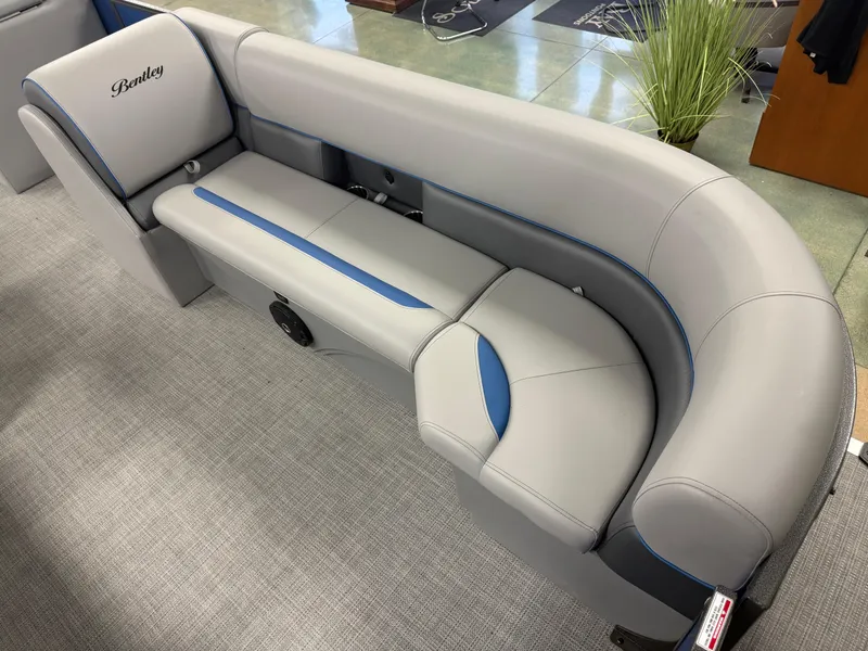 Slide: The Image of 2025 Bentley Pontoons Legacy 240 Cruise interior seating, featuring sleek gray upholstery with blue accents. - 9