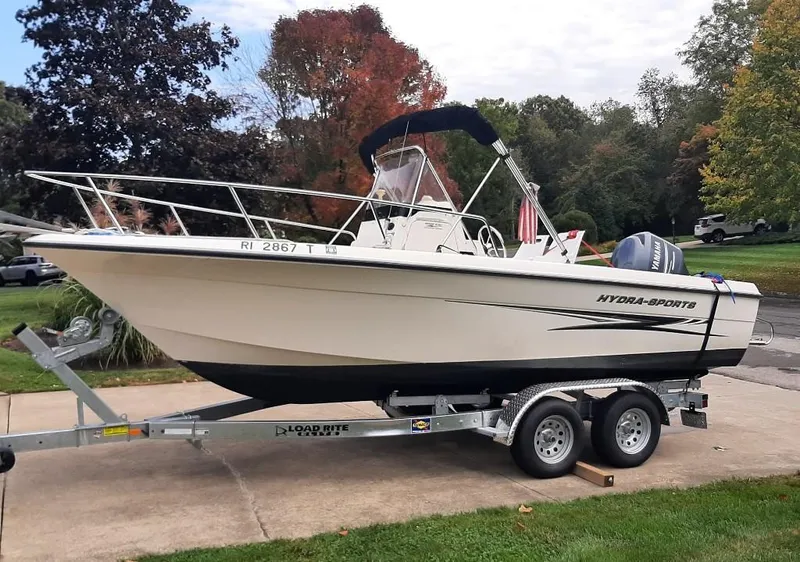 Slide: The Image of 2004 Hydra-Sports Lightning 212 CC boat on trailer, parked outdoors with autumn trees in background. - 0