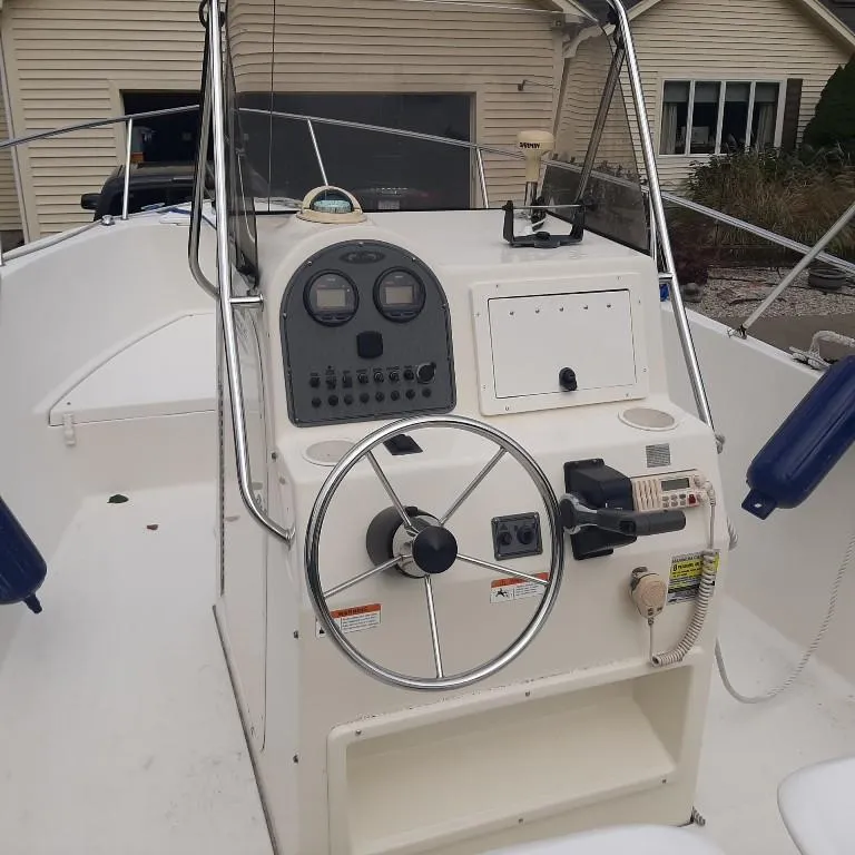 Slide: The Image of 2004 Hydra-Sports Lightning 212 CC boat console with steering wheel and controls. - 4