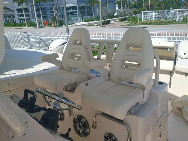 Slide: The Image of 2025 Grady-White Canyon 306 boat interior with dual captain's chairs and steering wheel. - 14