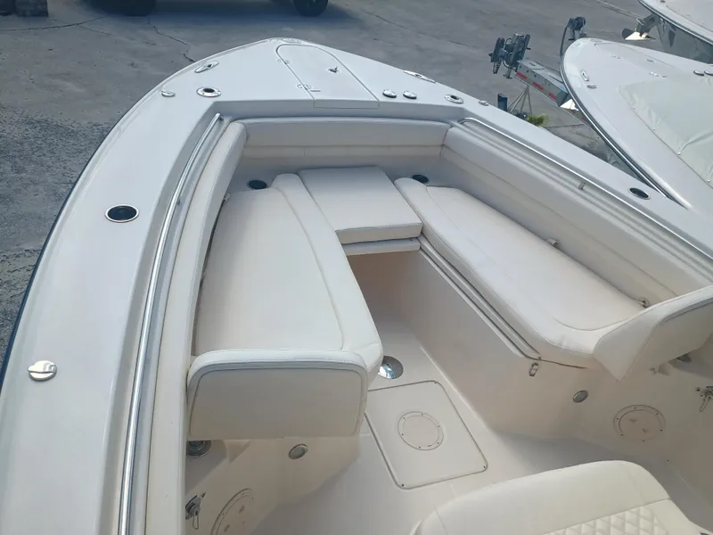 Slide: The Image of 2025 Grady-White Canyon 306 boat interior with cushioned seating and sleek design. - 17