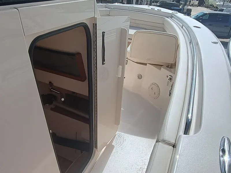 Slide: The Image of 2025 Grady-White Canyon 306 boat interior with open cabin door. - 18