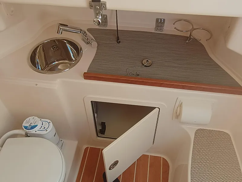 Slide: The Image of 2025 Grady-White Canyon 306 boat interior with sink, toilet, and storage. - 21