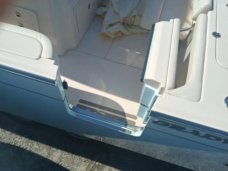 Slide: The Image of 2025 Grady-White Canyon 306 boat interior, featuring sleek seating and storage compartments. - 26