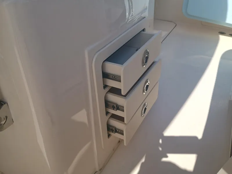 Slide: The Image of 2025 Grady-White Canyon 306 boat storage drawers, open and sunlit. - 28