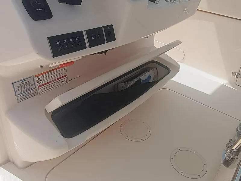 Slide: The Image of 2025 Grady-White Canyon 306 boat console with open storage compartment. - 33