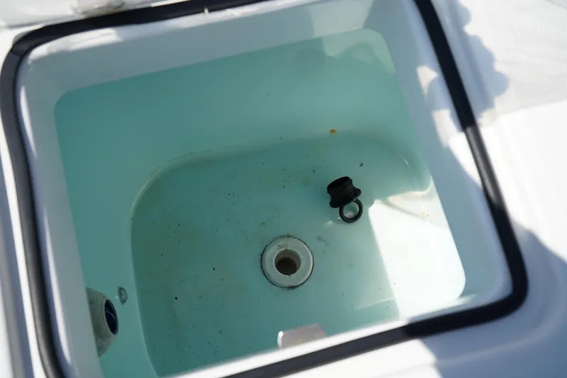 Slide: The Image of Livewell compartment in 2018 Edgewater 262 CX boat, partially filled with water. - 14