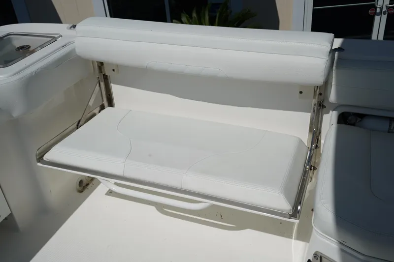 Slide: The Image of 2018 Edgewater 262 CX boat with white foldable seat and stainless steel frame. - 16