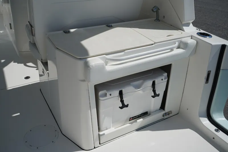 Slide: The Image of 2018 Edgewater 262 CX boat interior with built-in cooler storage compartment. - 17