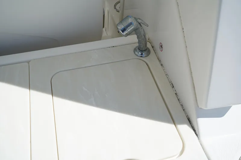 Slide: The Image of 2018 Edgewater 262 CX boat sink area with faucet and cover. - 19