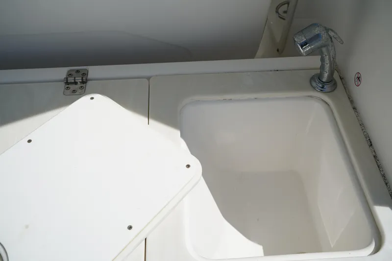 Slide: The Image of Edgewater 262 CX 2018 boat sink with faucet and storage compartment. - 20