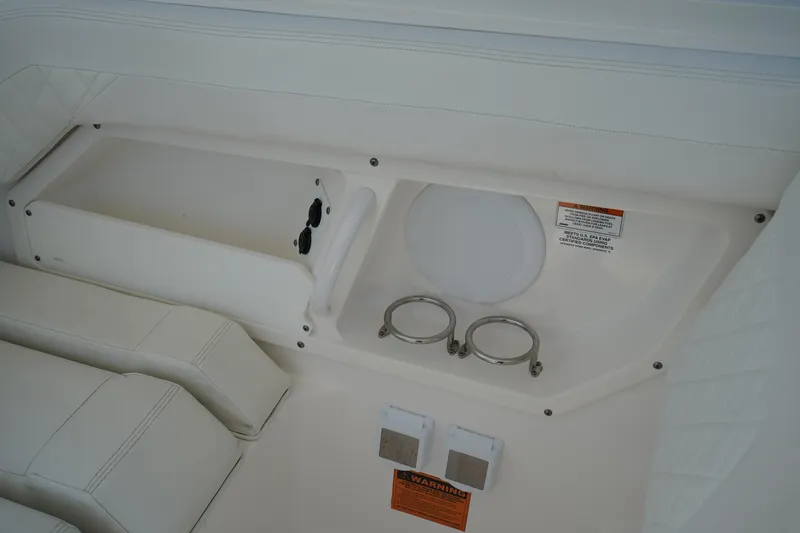 Slide: The Image of Interior view of 2018 Edgewater 262 CX boat, featuring cup holders and seating area. - 21