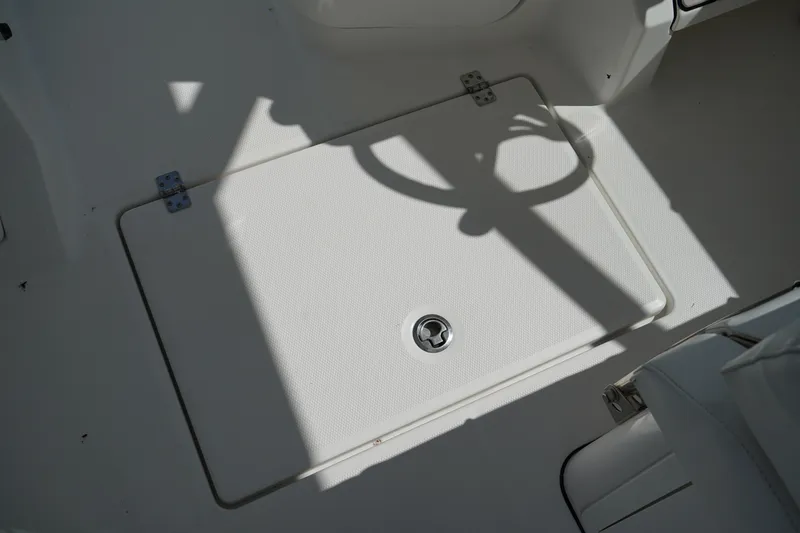 Slide: The Image of 2018 Edgewater 262 CX boat deck with storage hatch and shadow. - 32