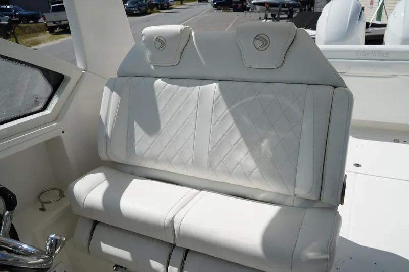 Slide: The Image of Luxurious white seating on 2018 Edgewater 262 CX boat, featuring diamond stitching. - 35