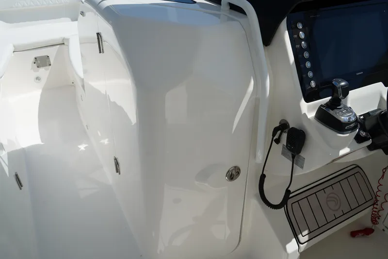 Slide: The Image of 2018 Edgewater 262 CX boat interior with control panel and storage compartment. - 42