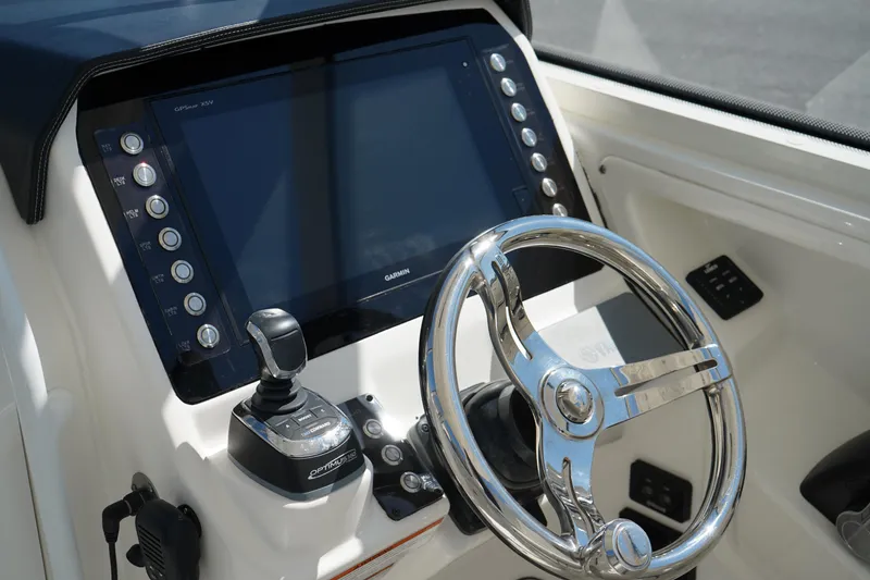 Slide: The Image of Steering console of 2018 Edgewater 262 CX boat with modern controls and display. - 43