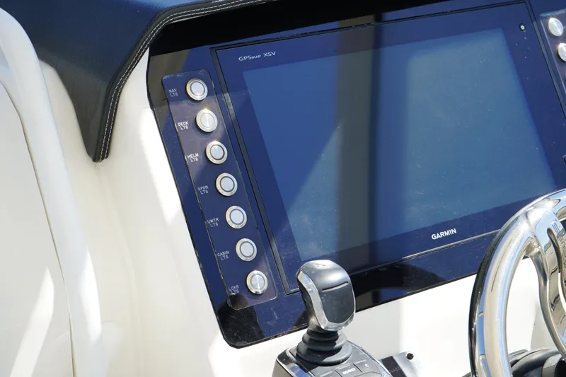 Slide: The Image of Edgewater 262 CX 2018 boat dashboard with Garmin display and control panel. - 44