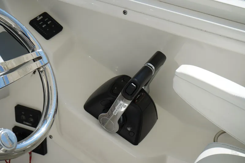 Slide: The Image of 2018 Edgewater 262 CX boat controls and steering wheel close-up. - 46