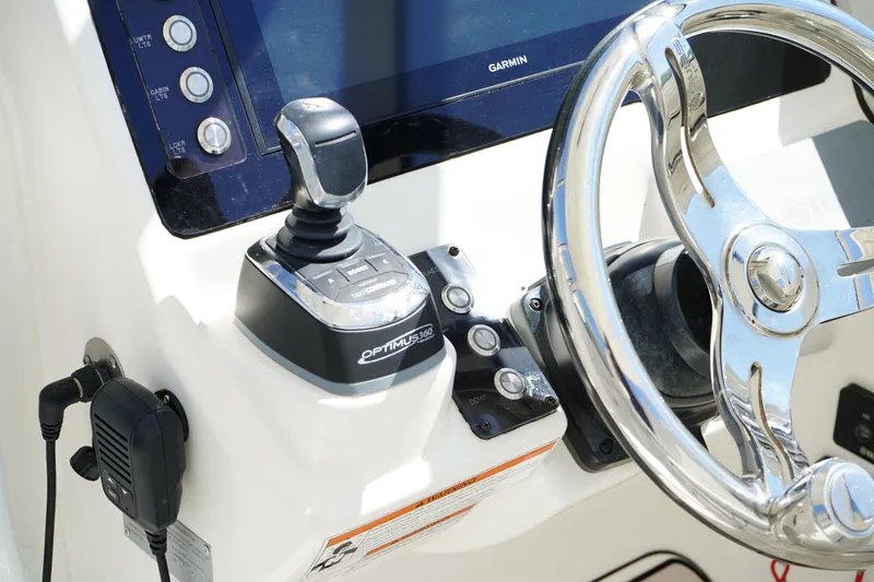 Slide: The Image of 2018 Edgewater 262 CX boat dashboard with steering wheel and control panel. - 48