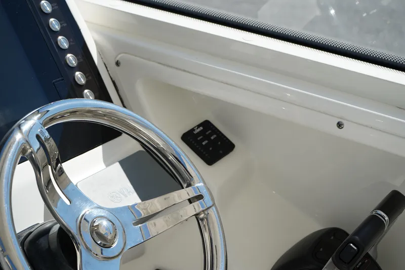 Slide: The Image of Steering wheel and controls of 2018 Edgewater 262 CX boat cockpit. - 49