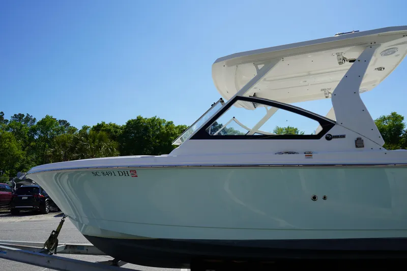 Slide: The Image of 2018 Edgewater 262 CX boat on trailer under clear blue sky. - 6