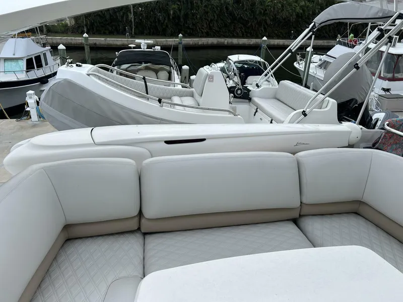 Slide: The Image of 2008 Princess 67 Flybridge yacht with luxurious white seating at a marina. - 14