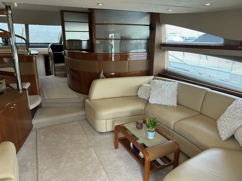 Slide: The Image of Luxurious interior of 2008 Princess 67 Flybridge yacht with beige seating and wooden accents. - 19