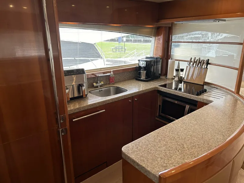 Slide: The Image of Luxurious kitchen in 2008 Princess 67 Flybridge yacht with modern appliances and wood finish. - 21