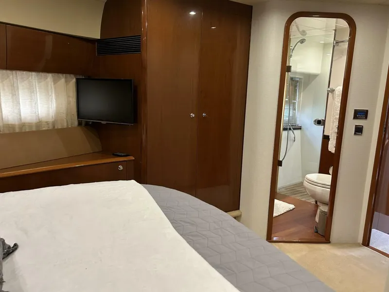 Slide: The Image of Luxurious 2008 Princess 67 Flybridge yacht bedroom with ensuite bathroom and TV. - 28