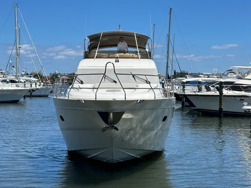Slide: The Image of 2008 Princess 67 Flybridge yacht docked in marina under clear blue sky. - 3